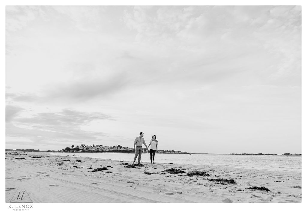 Black and White photo taken at the beach during an Engagement Session at the Crane Estates