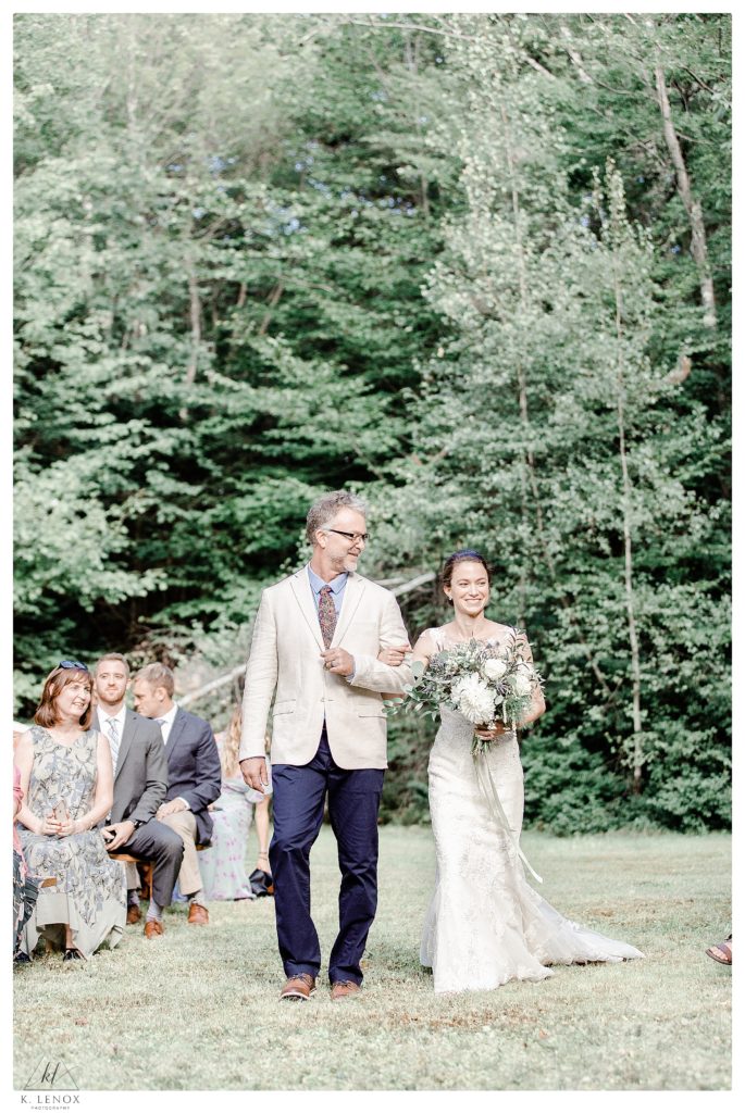 Light and airy photo of a bride and her dad walking down the aisle for her simple Tamworth NH Wedding. 
