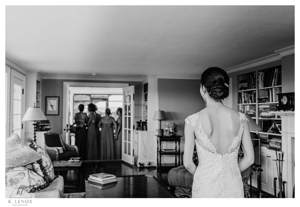Black and White photo of a bride waiting for her bridesmaids to see her all dressed and ready to get married. 