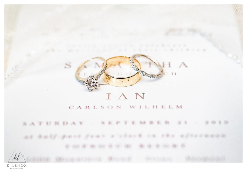 Wedding rings photographed on a simple white invitation