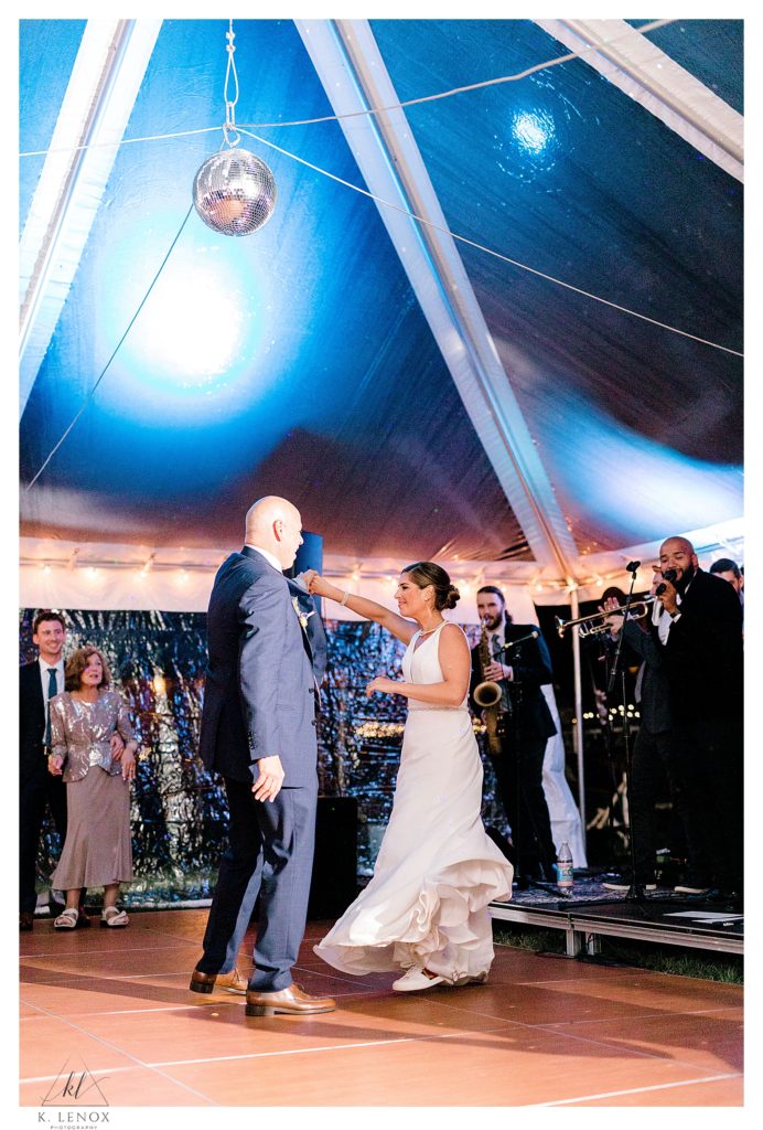 Bride and her dad dance under a clear tent at Lake Falls Lodge during their fall wedding. 