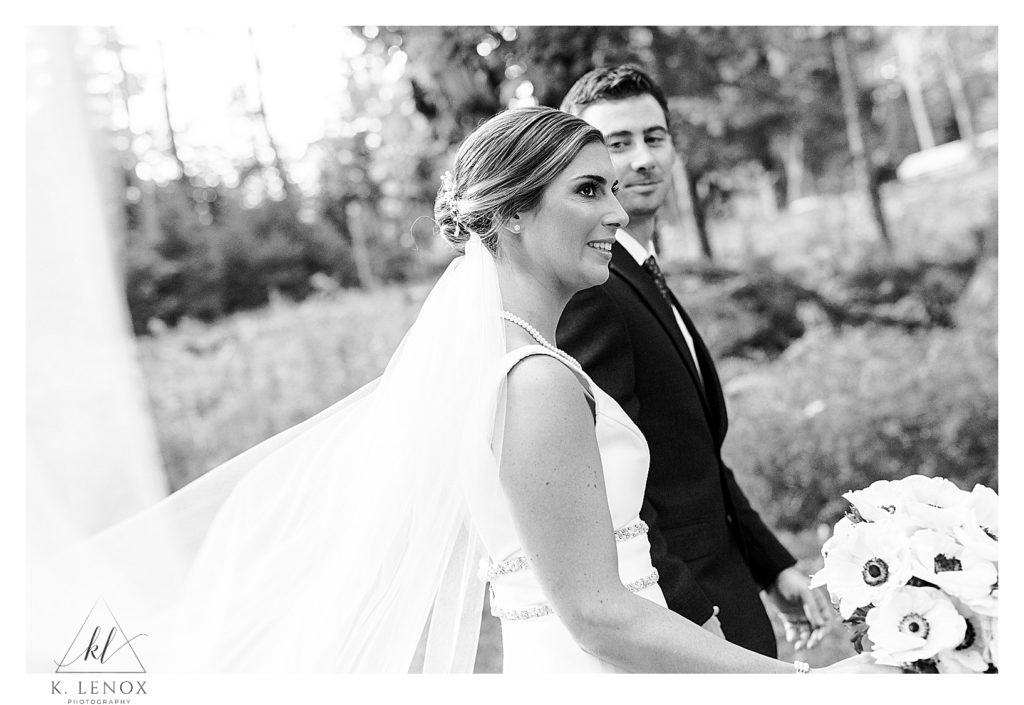 Black and White candid photo of a bride and groom on their wedding day at Lake Falls lodge. 