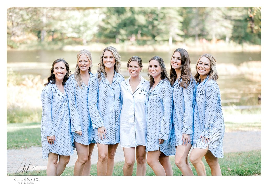 Bride and her bridesmaids pose for a picture while in matching Blue Pajamas.  