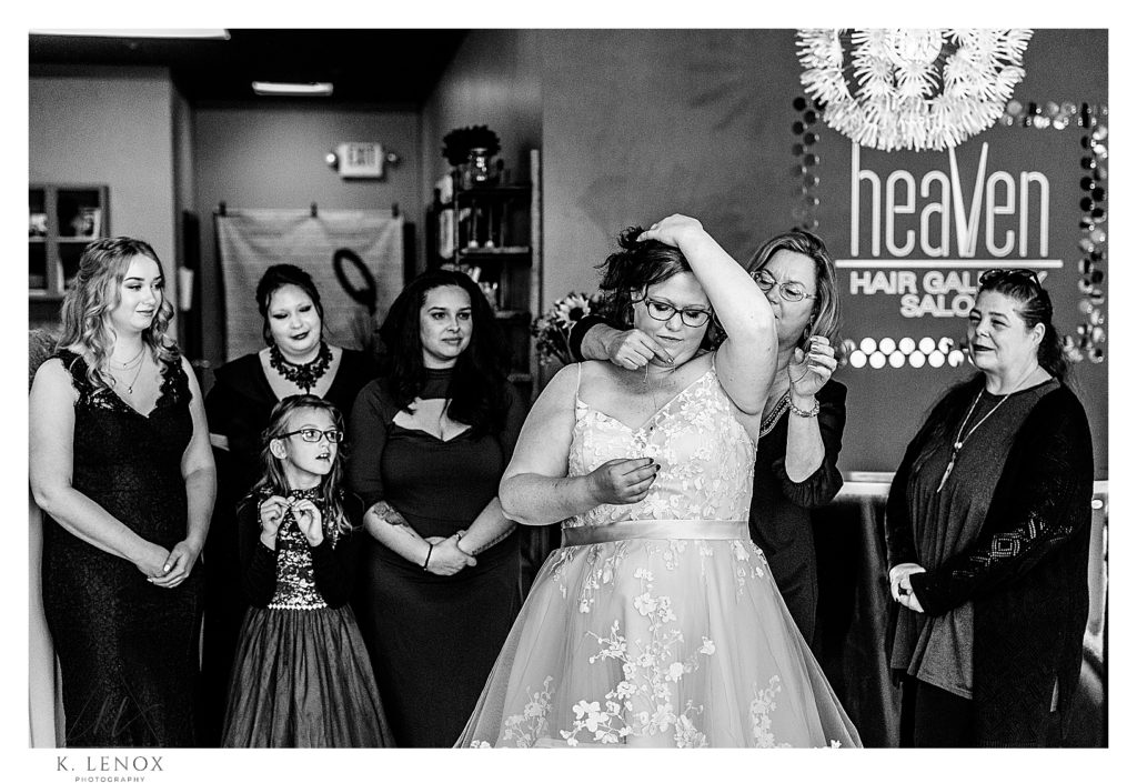Bride getting dressed at heave hair gallery in Keene NH. 
