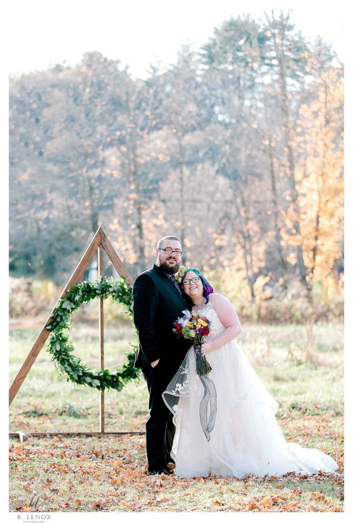 Harry Potter Themed Wedding at Stonewall Farm. Bride and Groom standing in front of 'Deathly Hallow" A custom made arbor. 