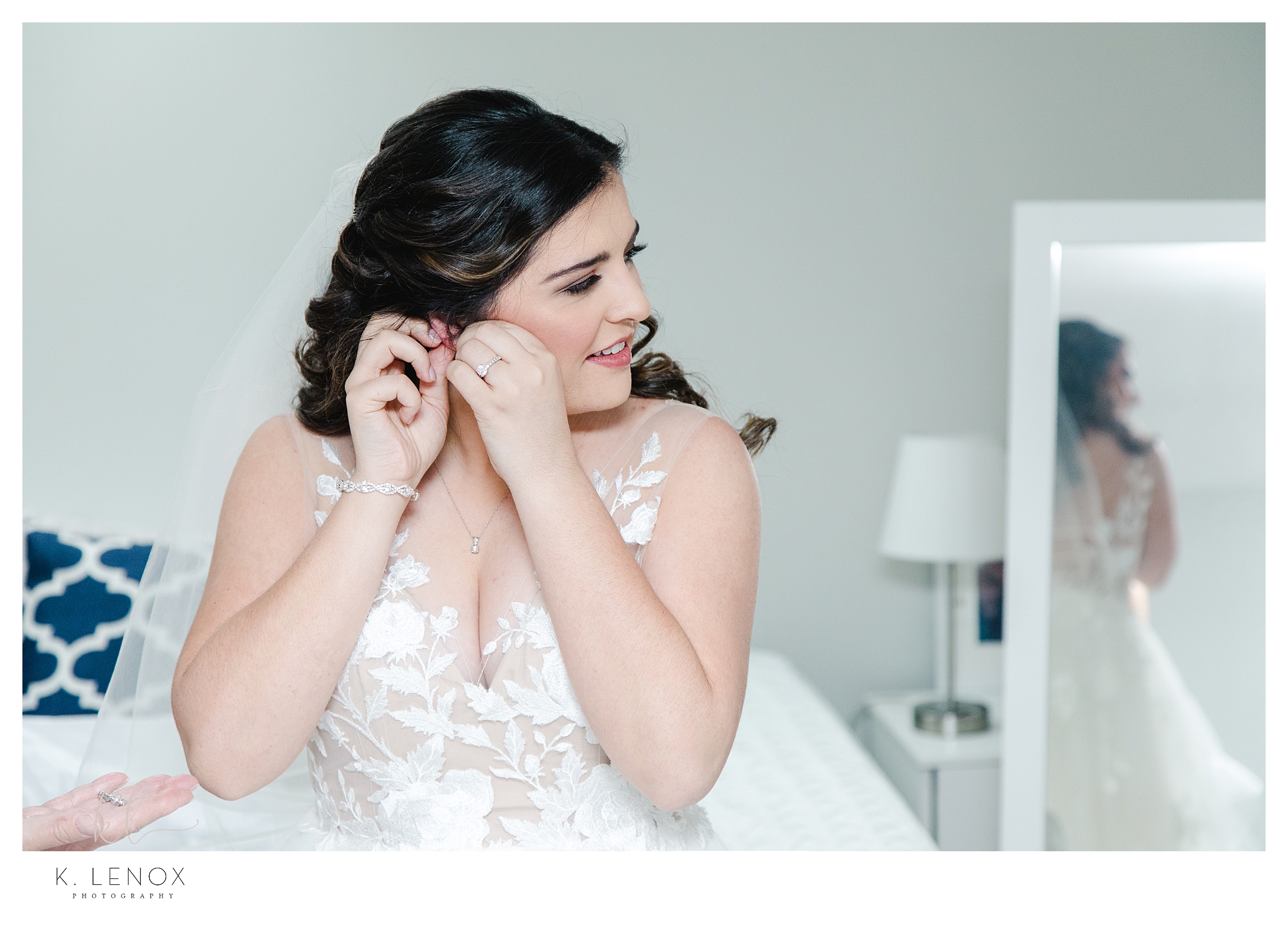 Beautiful Backyard Micro Wedding -  Light and Airy photo of a bride putting on her earrings. 