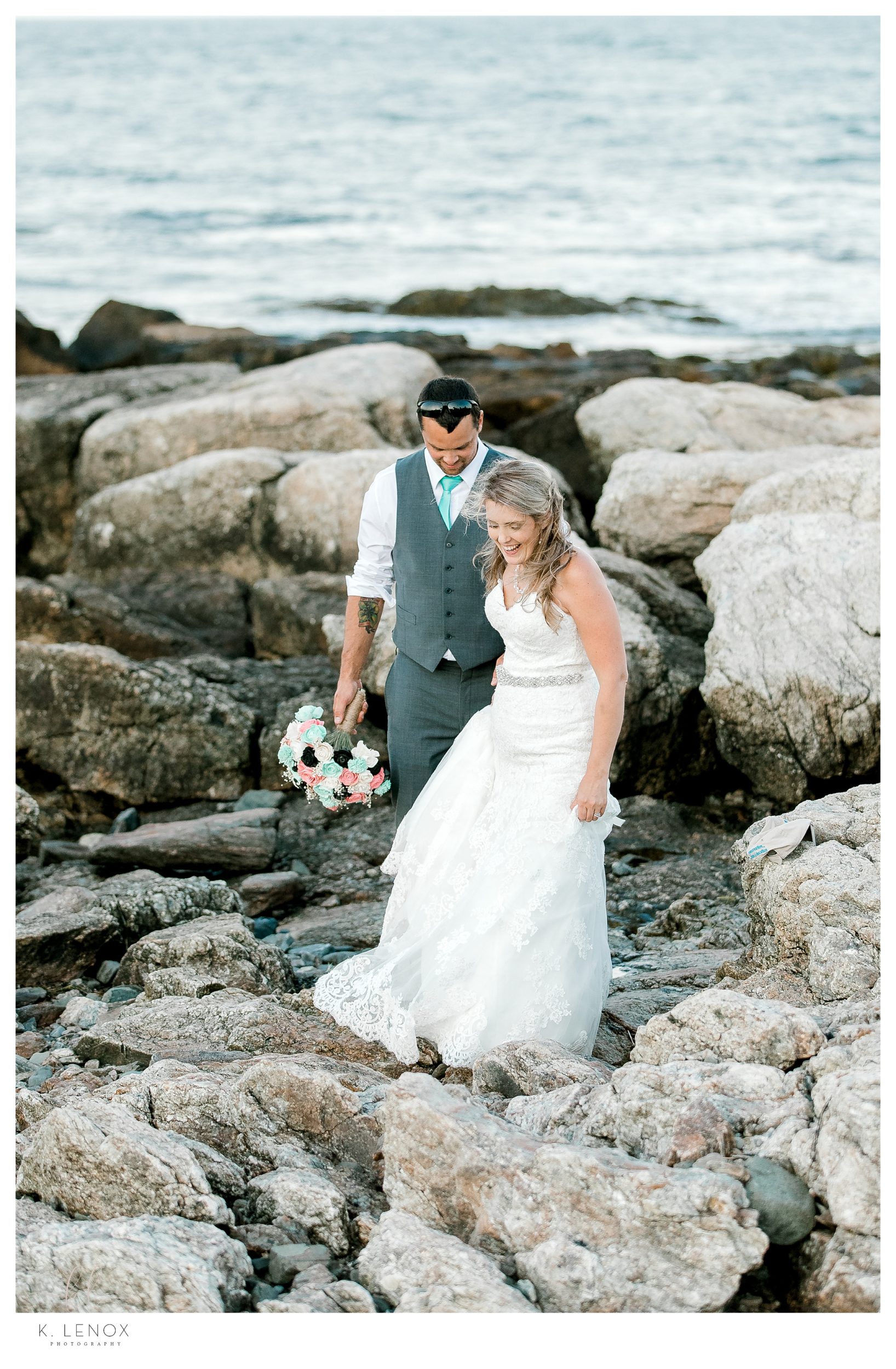 Bride and groom walk on the rocks near the ocean at the Seacoast Science center after their wedding