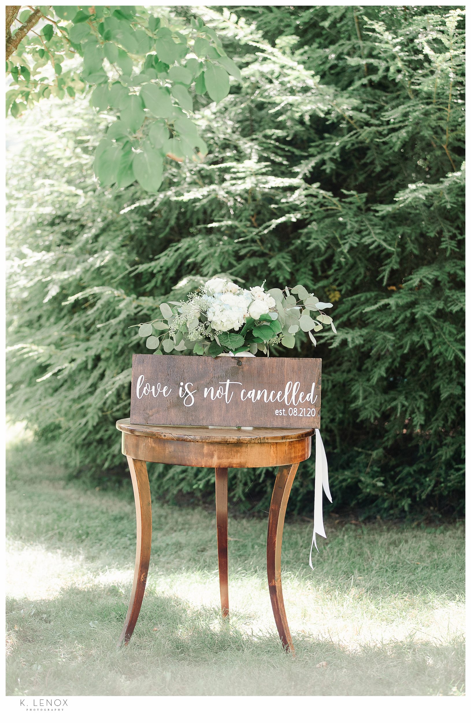 Light and Airy Micro Wedding at Moran Estates- Wooden Sign saying "Love is not cancelled"