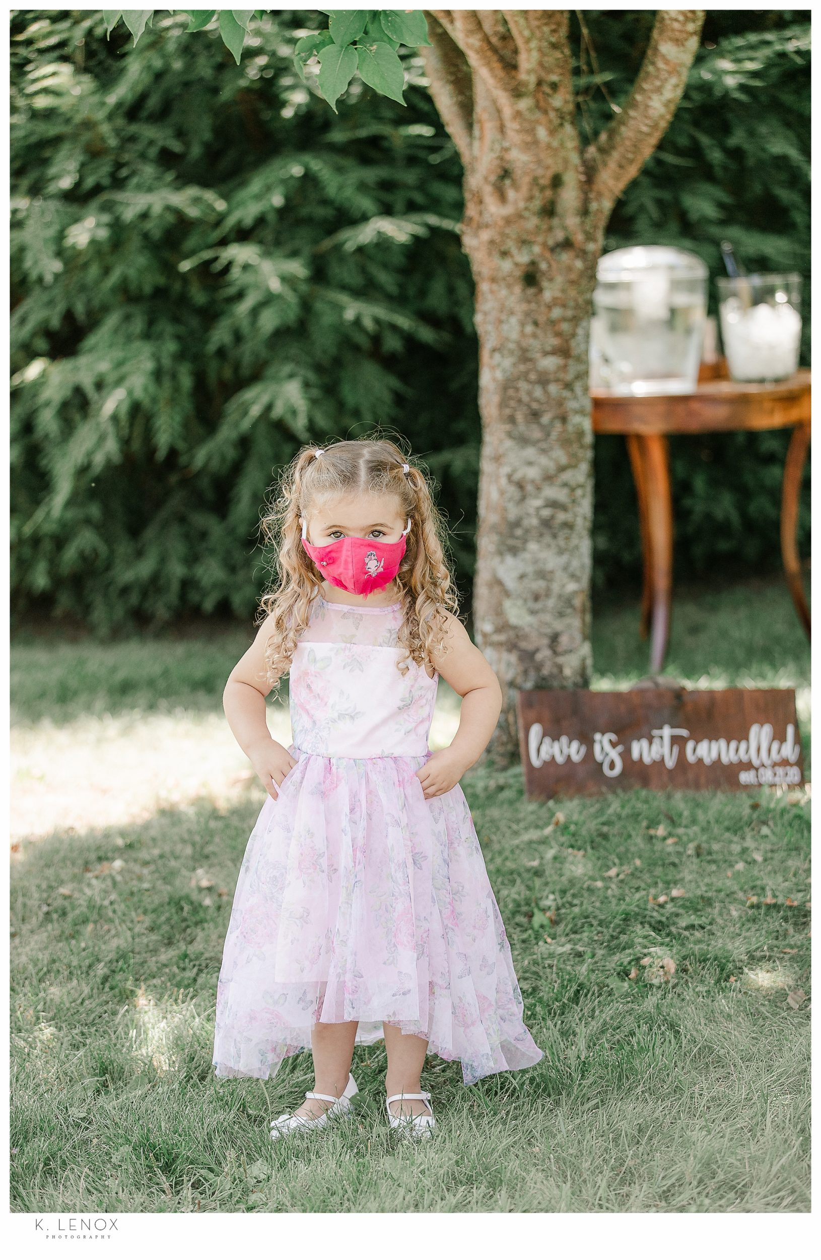 Light and Airy Micro Wedding at Moran Estates- Little girl wearing a pink facemask at a wedding
