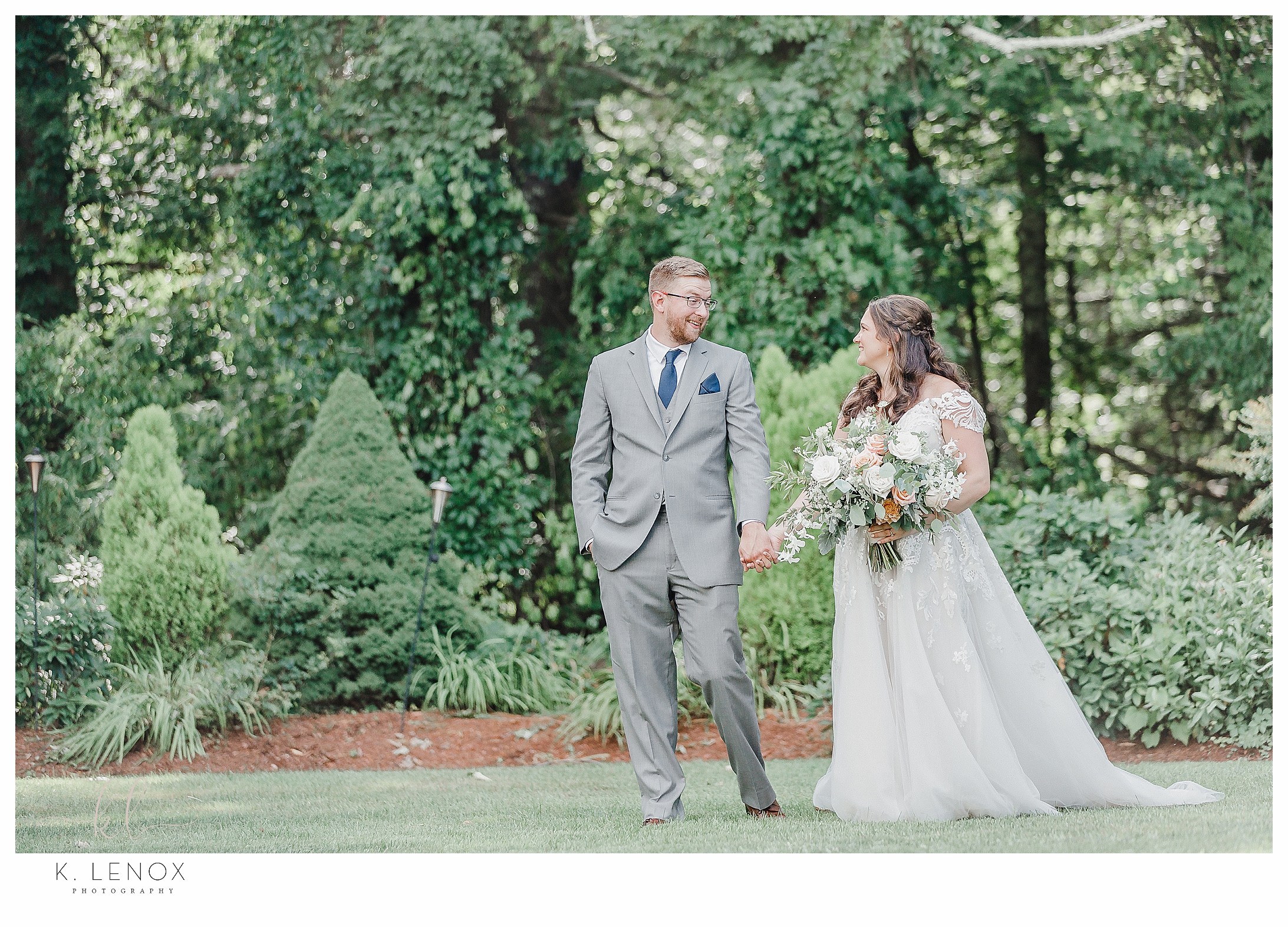 Summer Wedding at the Bedford Village Inn- Color photo of a bride and groom walking hand in hand. 