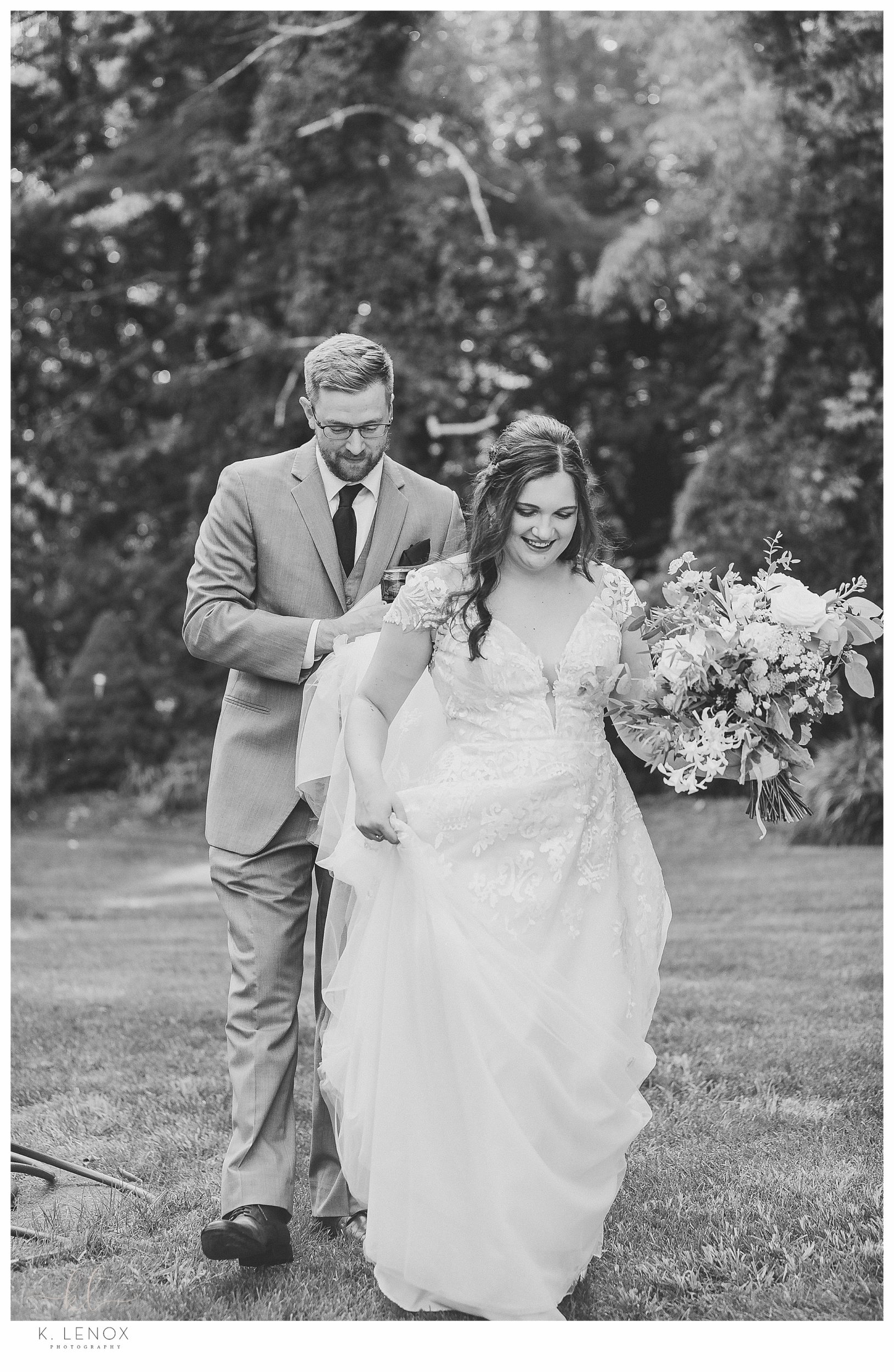 Summer Wedding at the Bedford Village Inn- Black and White photo of a bride and groom walking. 