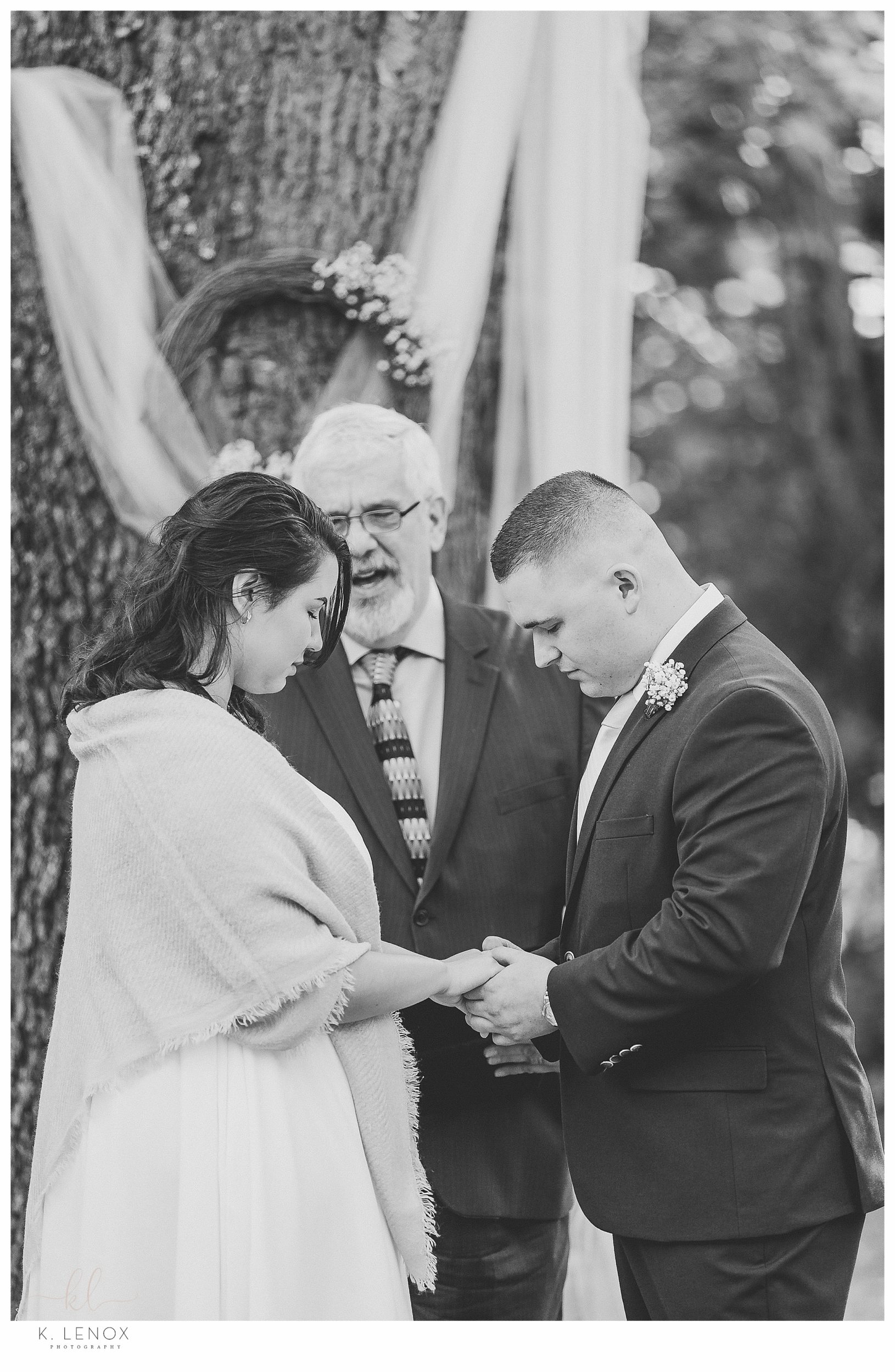 A moment of prayer during a sweet and simple backyard elopement.  Shot by K. Lenox photography