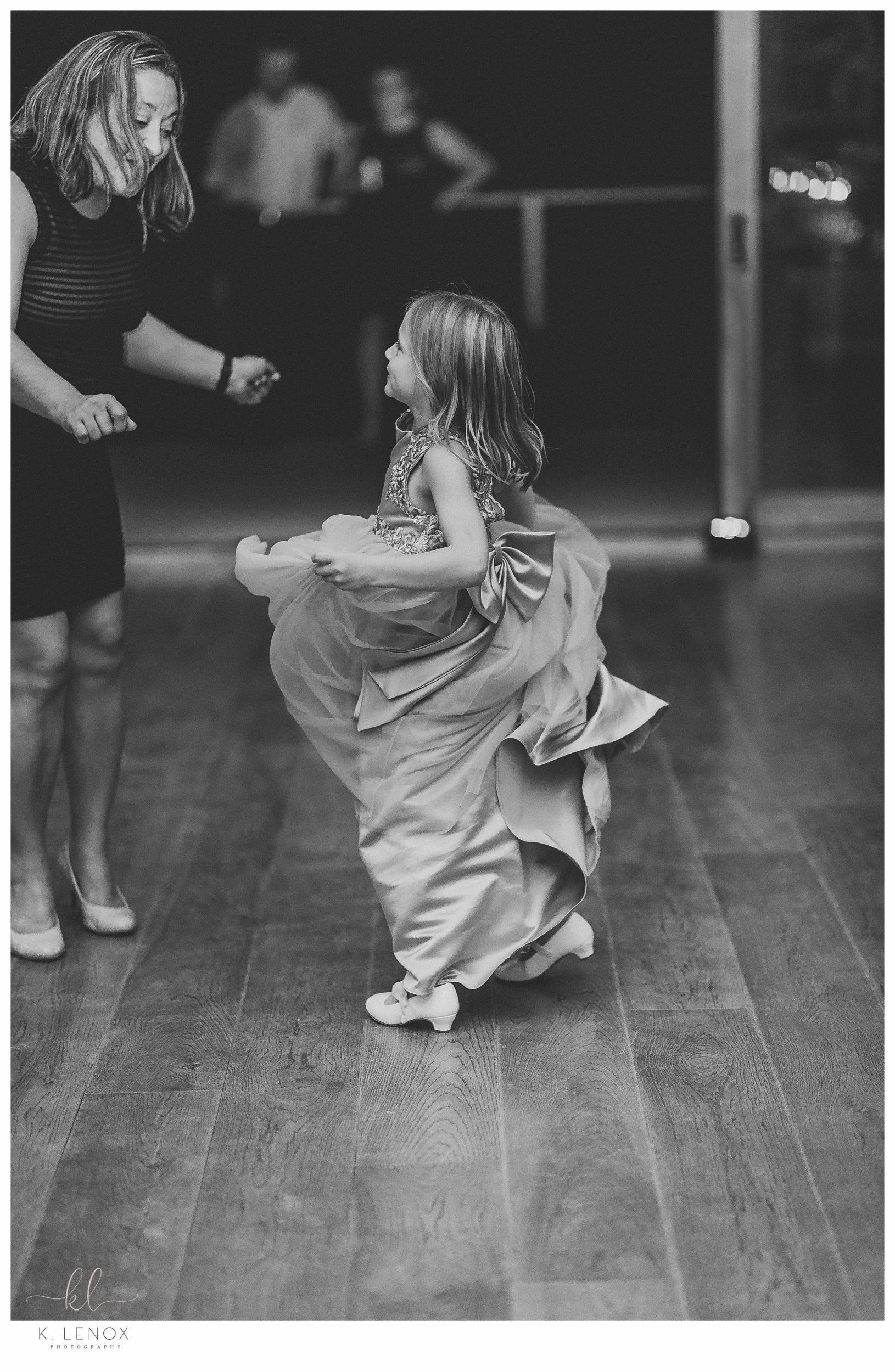 Wedding at Lake Falls Lodge- Black and white photo of a little girl dancing at the reception 