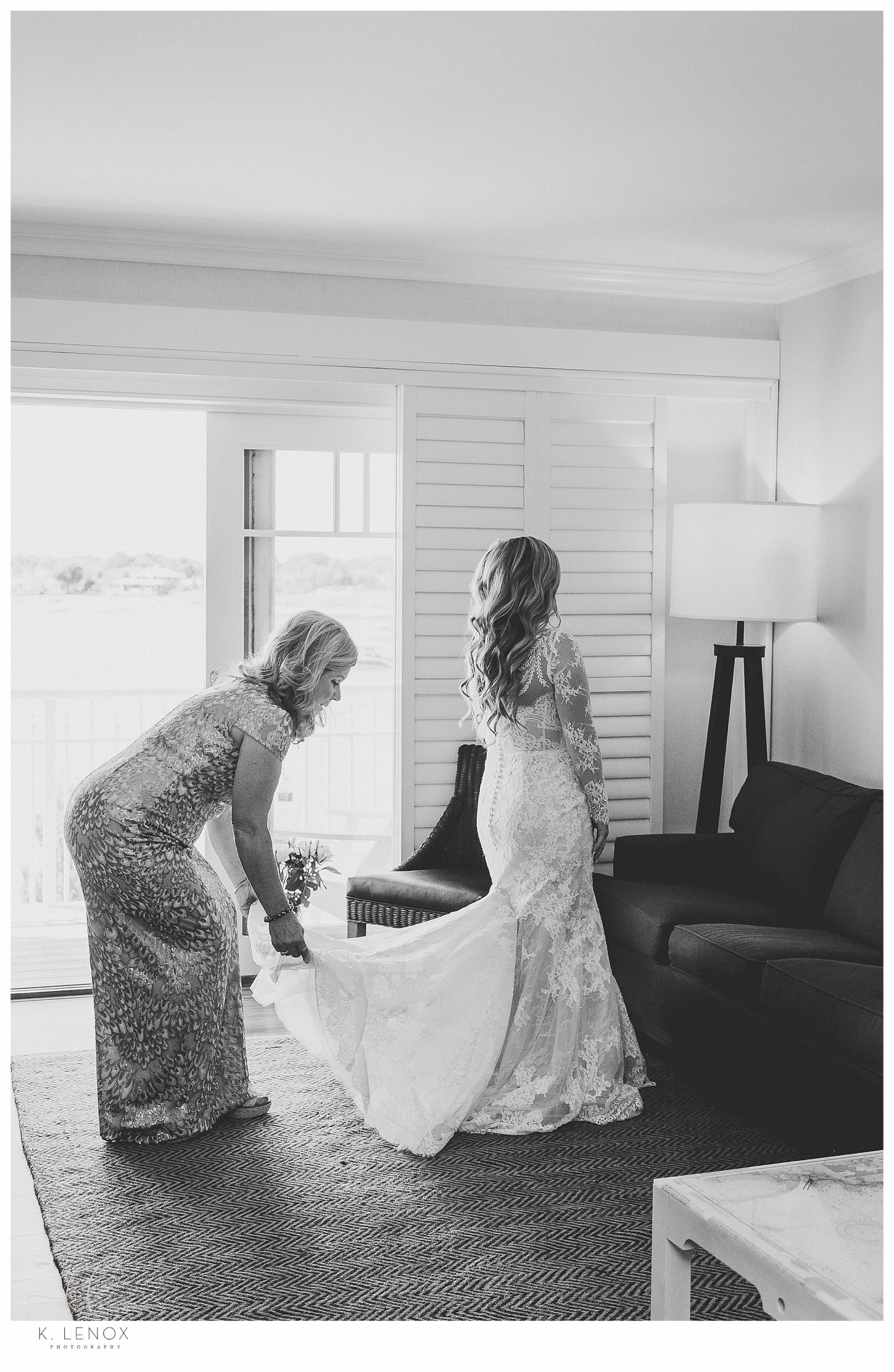 Black and White photo of a bride getting her dress on for her Wedding at the Wentworth Country Club