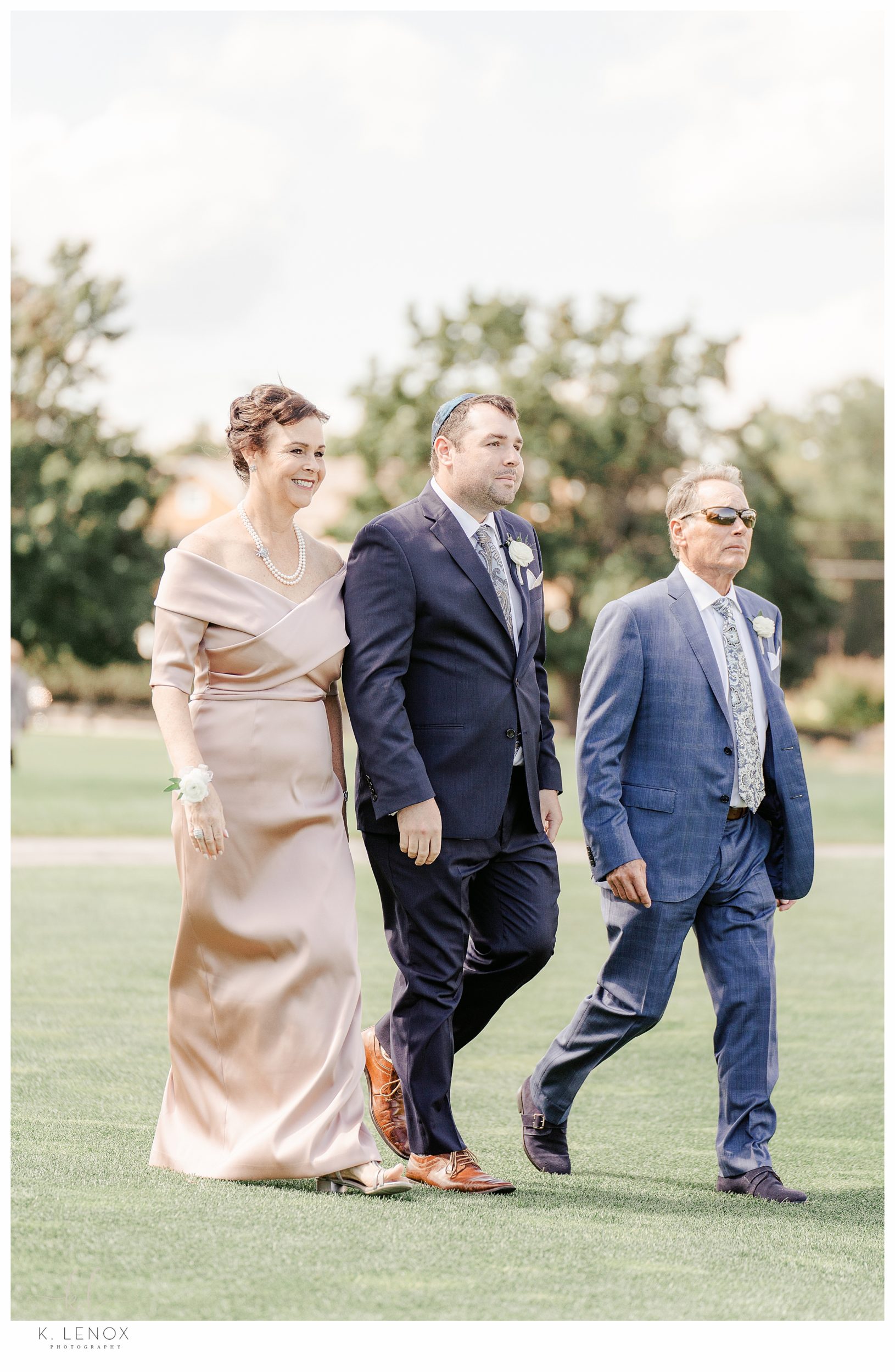 Wedding Ceremony at the Wentworth Country club in Portsmouth NH- Groom walks with his parents. 