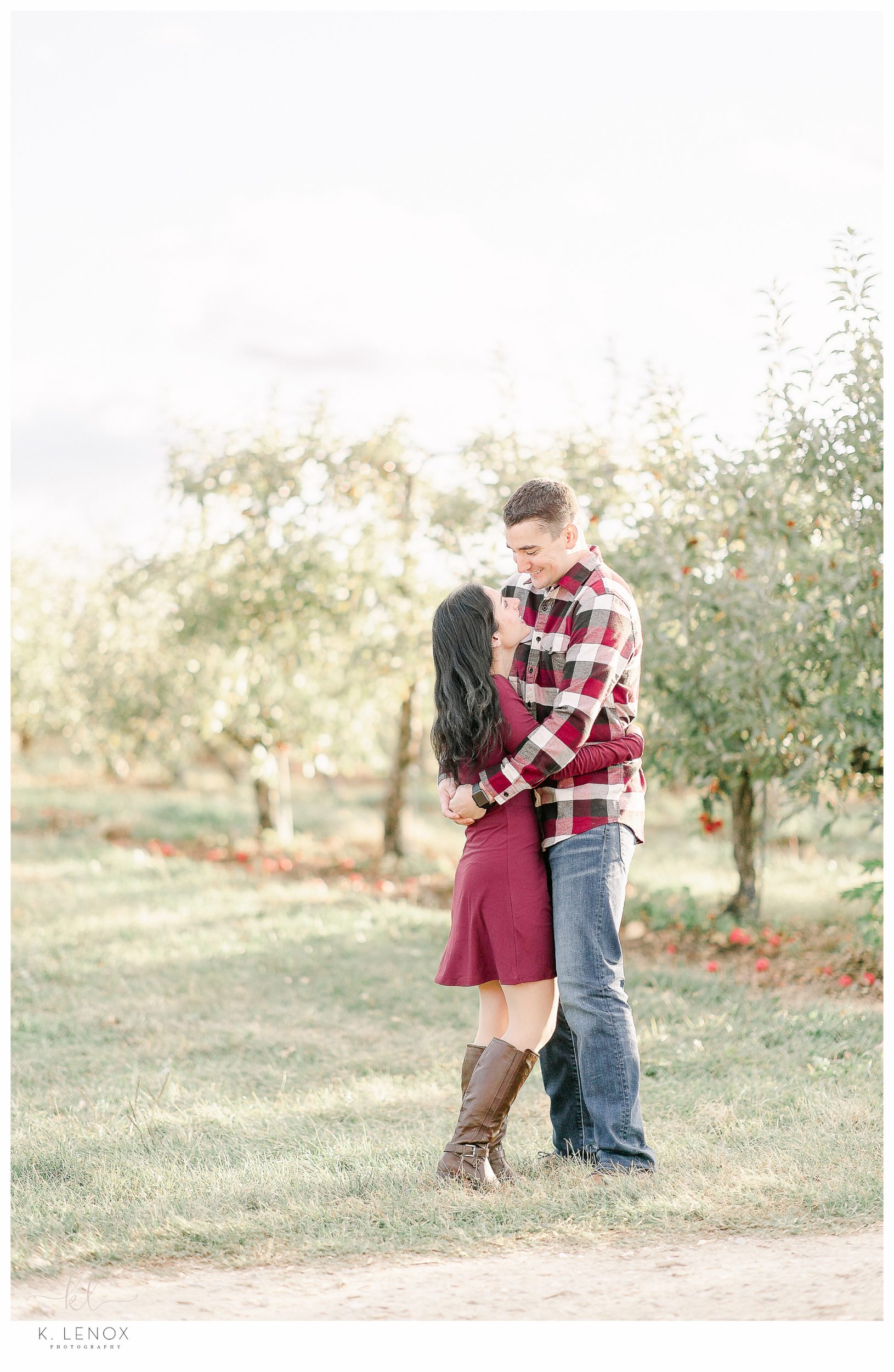 Fun and Carefree Engagement Session in NH- man and woman in an orchard. 