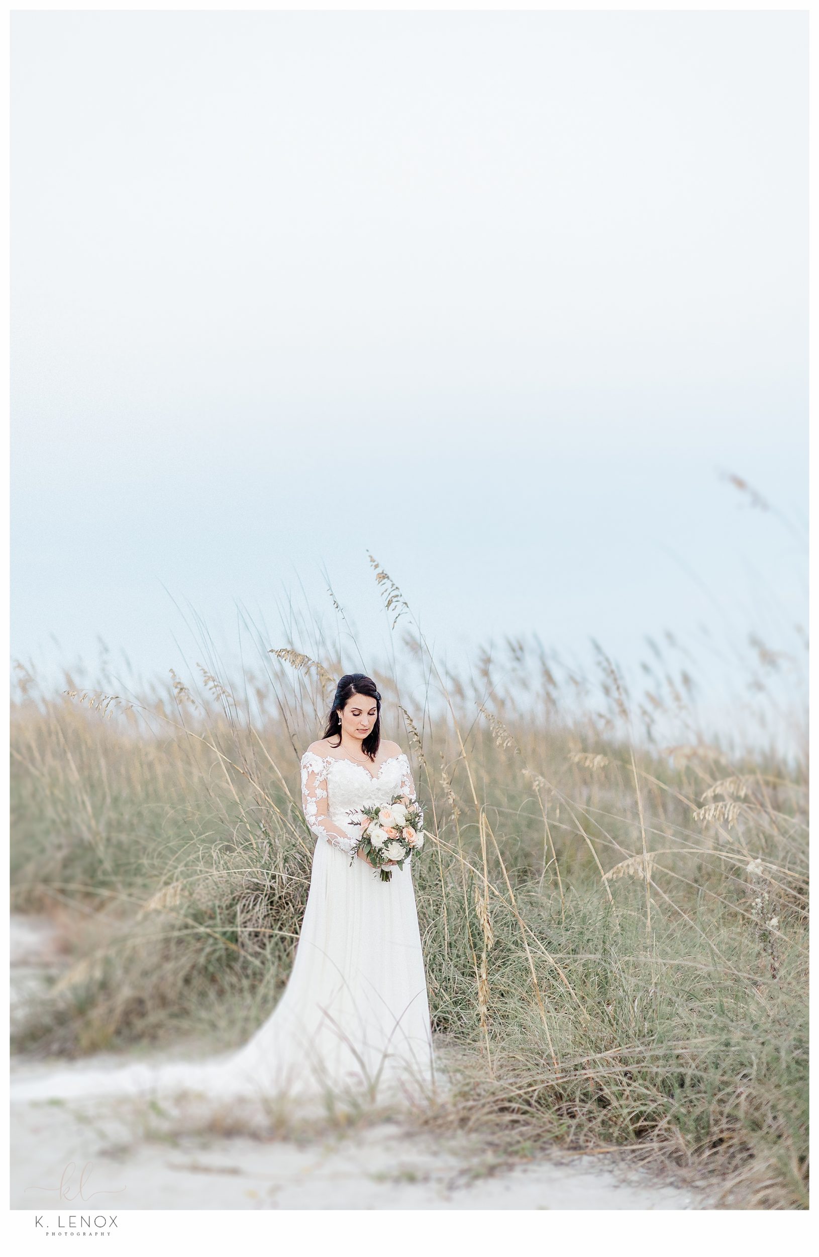 Hilton Head wedding- Bride in the sand dunes holding her bouquet