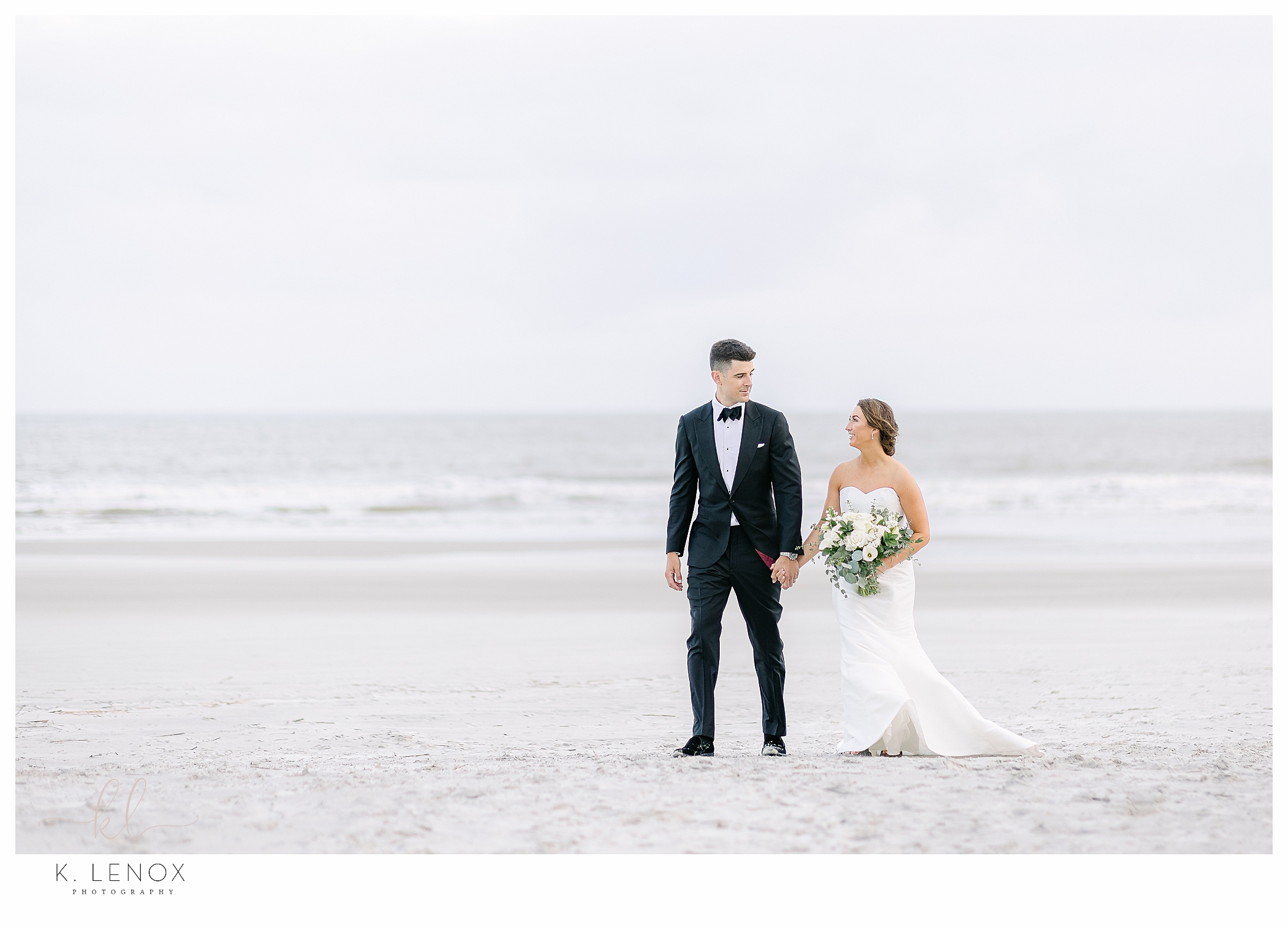 Bride and Groom Walking on the beach during their black tie beach on Hilton Head wedding day.