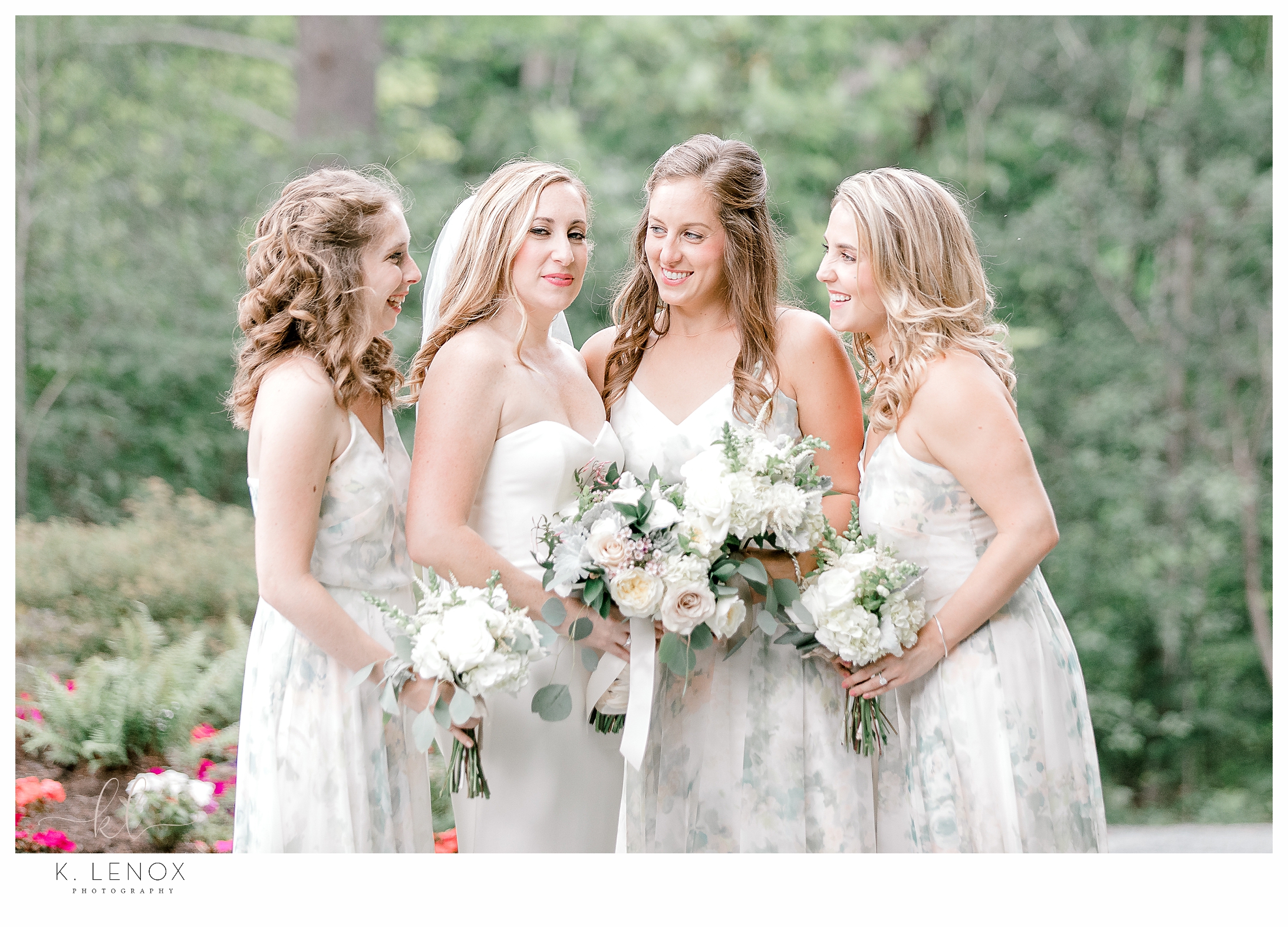 Candid photo of a bride and her bridesmaids by K. Lenox Photography. 