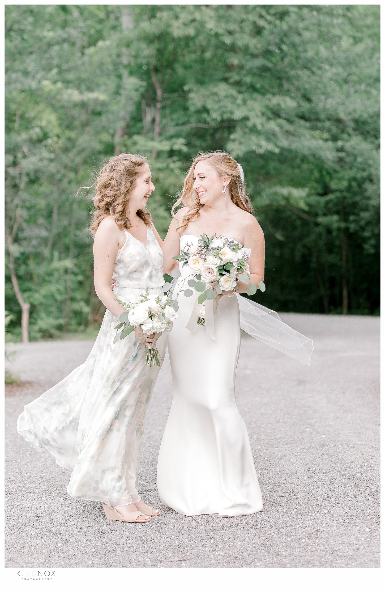 candid and unposed photo of A bride with her maid of honor 