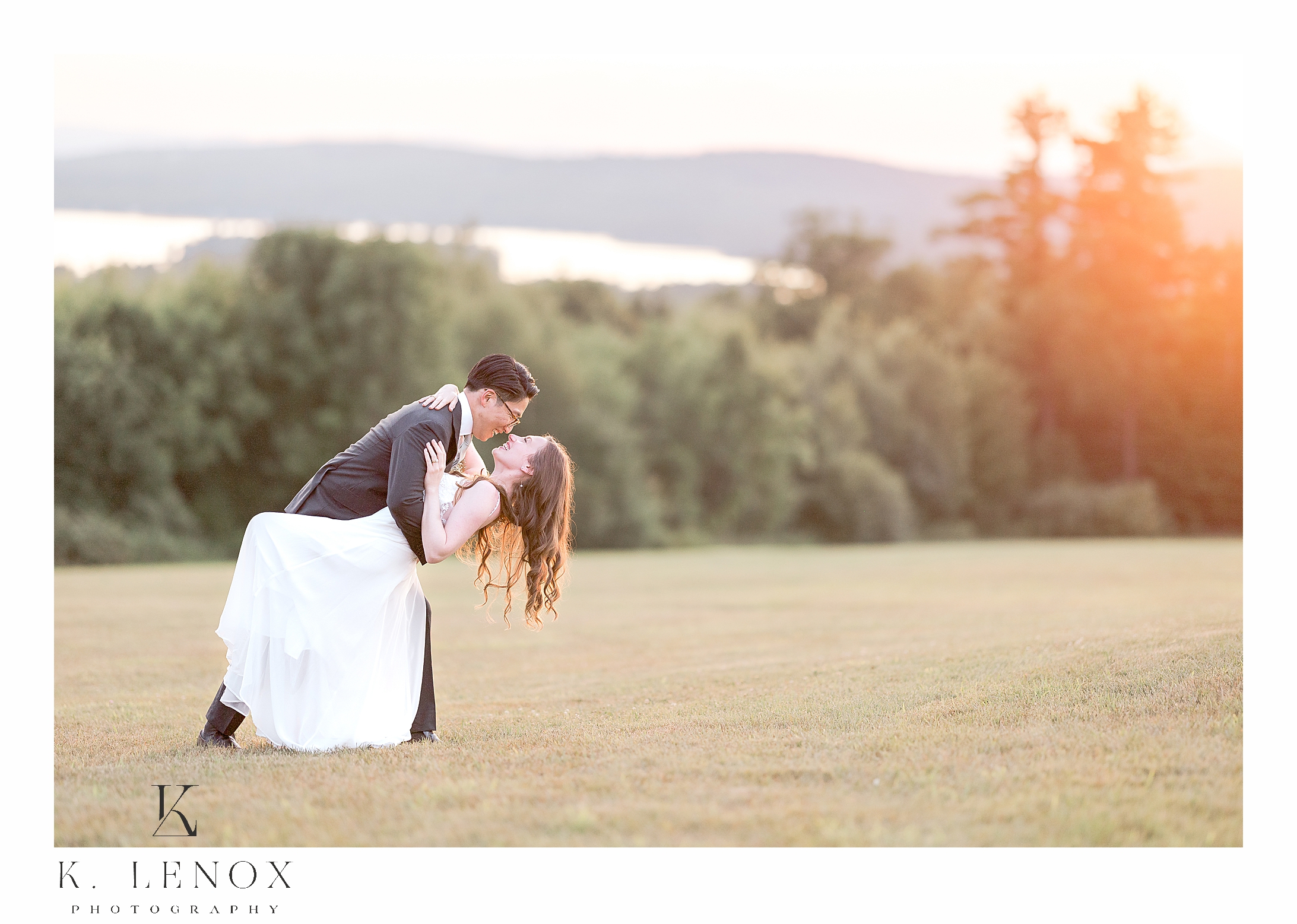 Golden Sunset overlooking a couple as they are posing for a photograph at the Lakeview Inn in wolfeboro, NH