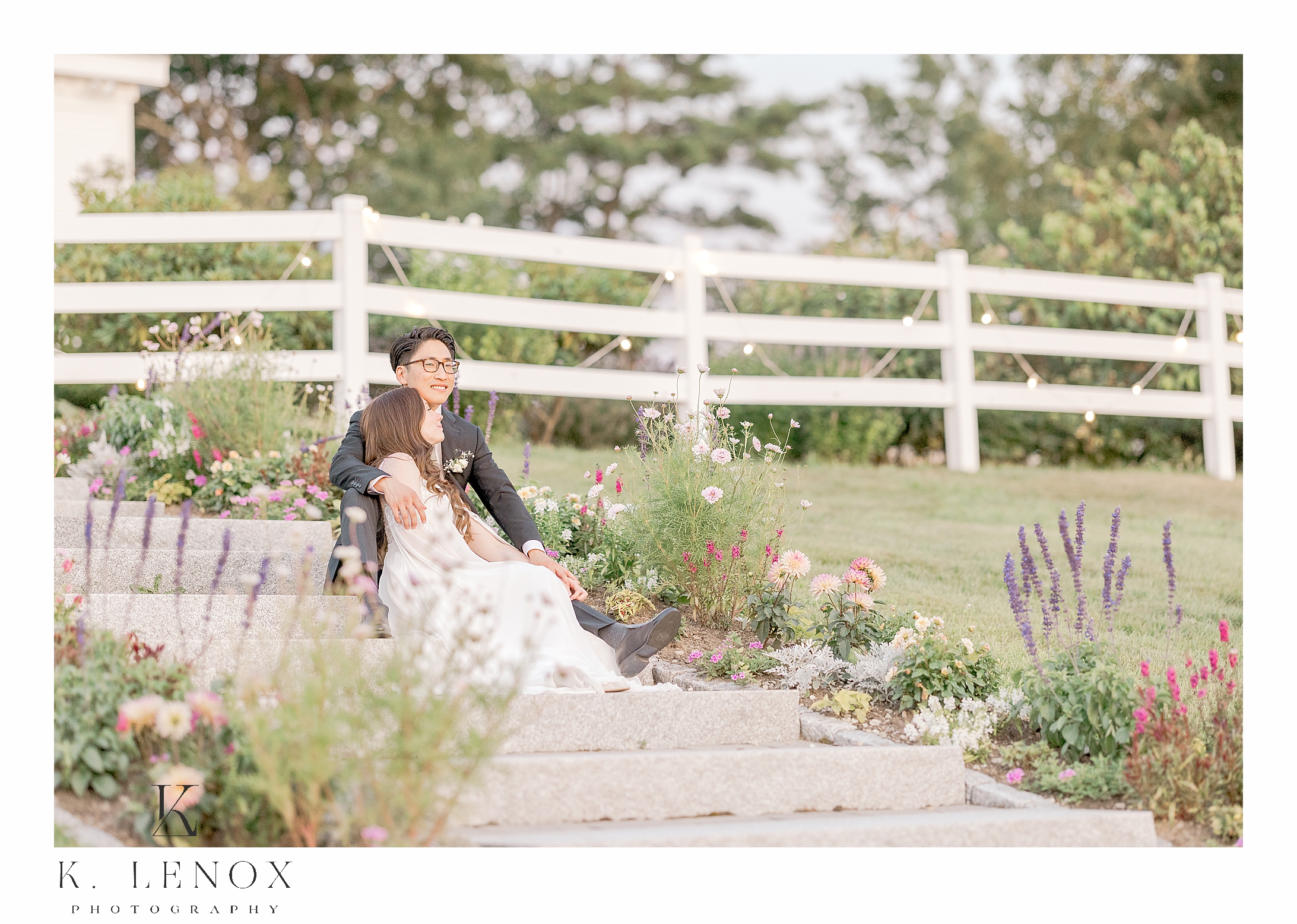 Bride and Groom sitting on the stairs on their wedding day at the Lakeview Inn Wedding in Wolfeboro NH